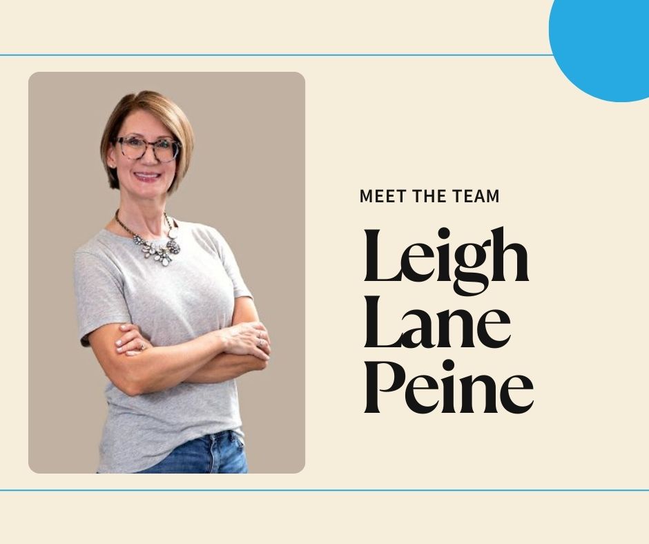 Leigh Lane Paine smilingly confidently with arms folded.