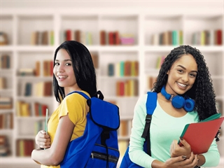 Two cheerful Brazilian female students with blue backpacks.