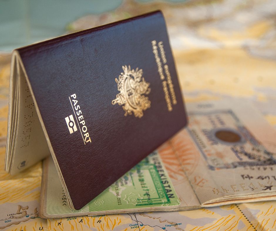 Passport and visa stamp on a map, indicating travel documentation.