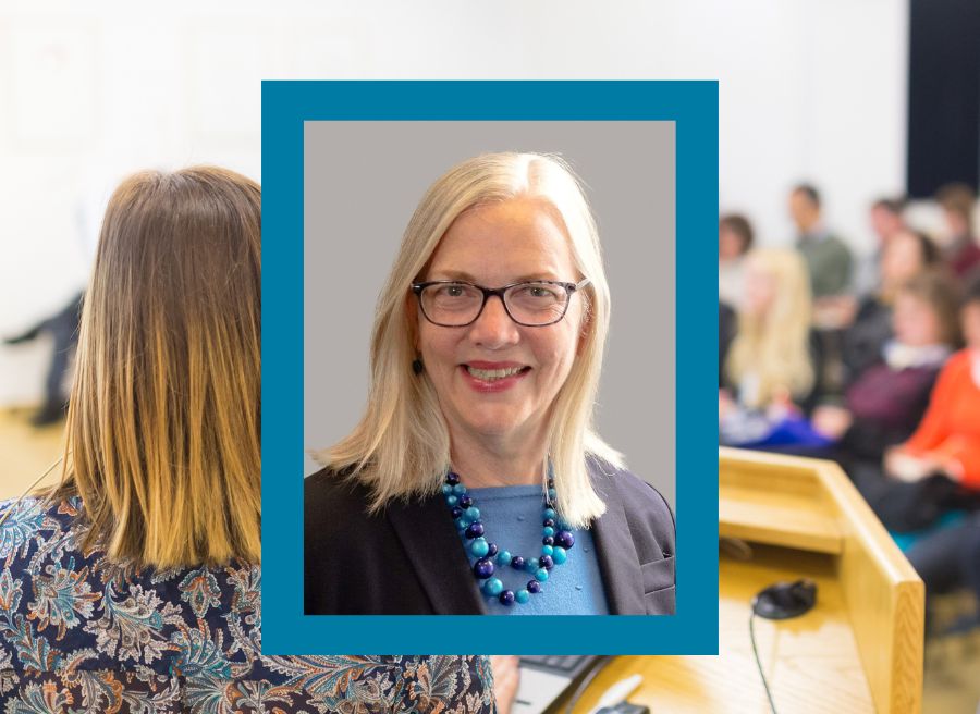 Margit Schatzman, President of ECE, smiling against a conference background