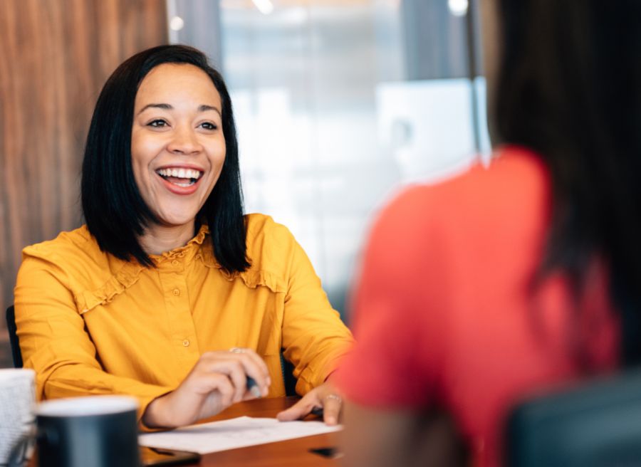 Female recruitment agent sitting in an office with a student