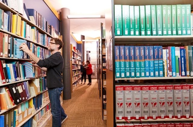 Three ECE® coworkers in the office library