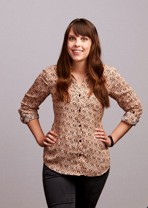 Alison Zaharias poses confidently in a leopard print blouse and black pants.