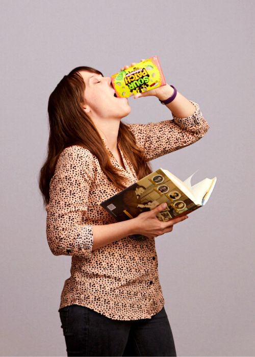 Alison Zaharias enjoys Sour Patch Kids while casually reading a book.