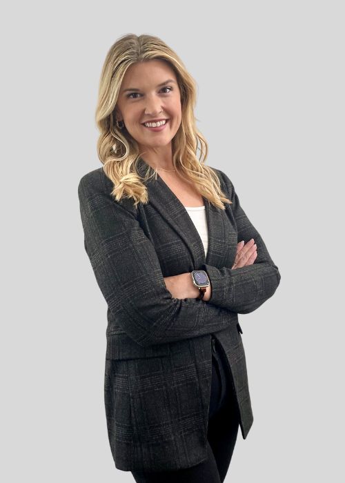 Professional image of Lauren Usma, arms crossed, wearing a smart black plaid blazer over a white top.